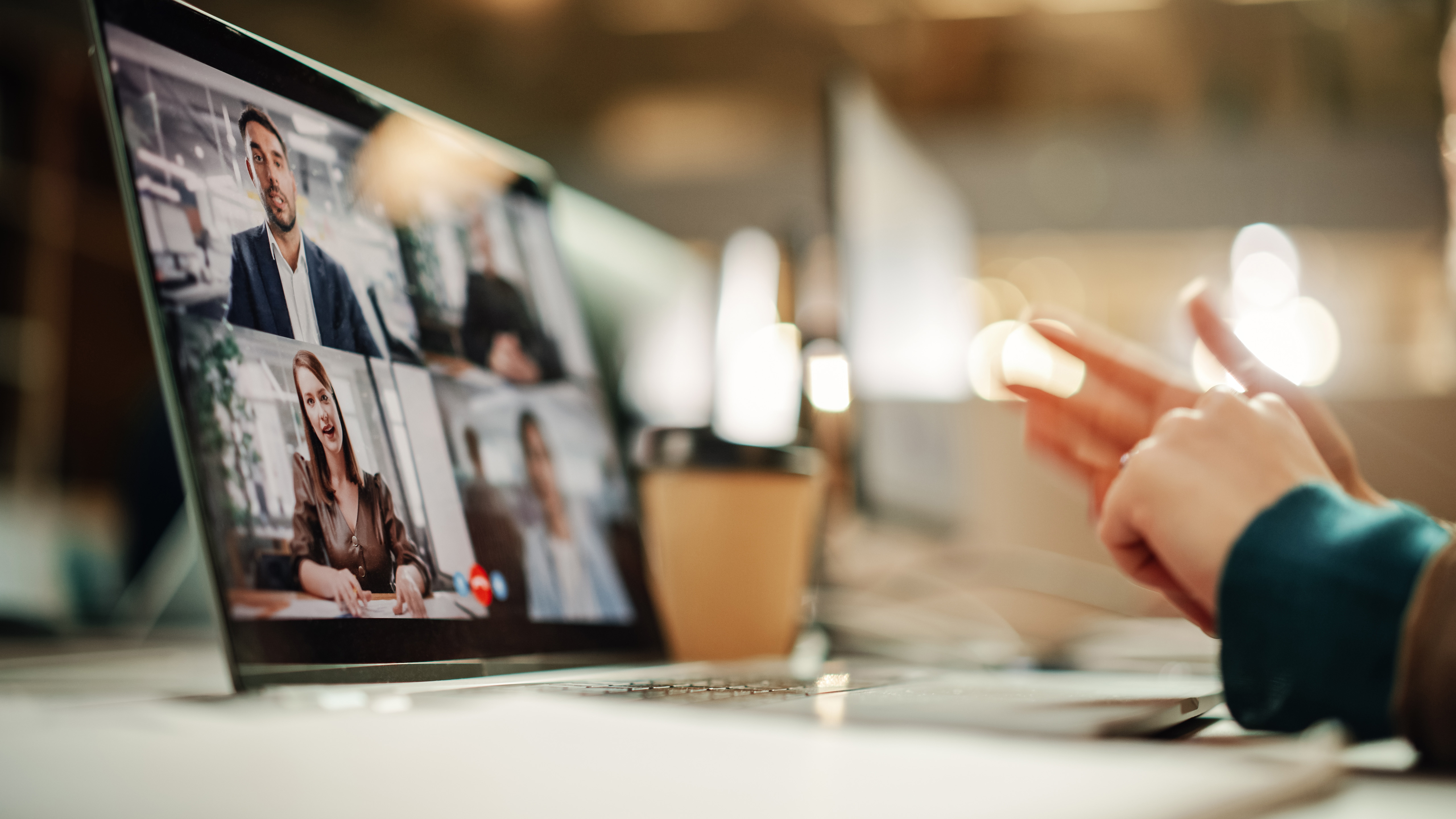 Laptop with faces on it indicating a webinar running