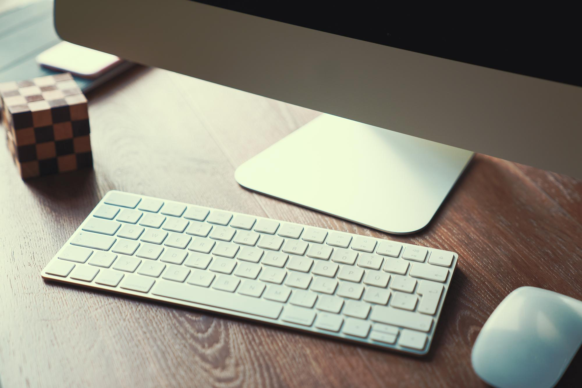 High angle view of keyboard and mouse by desktop pc on desk