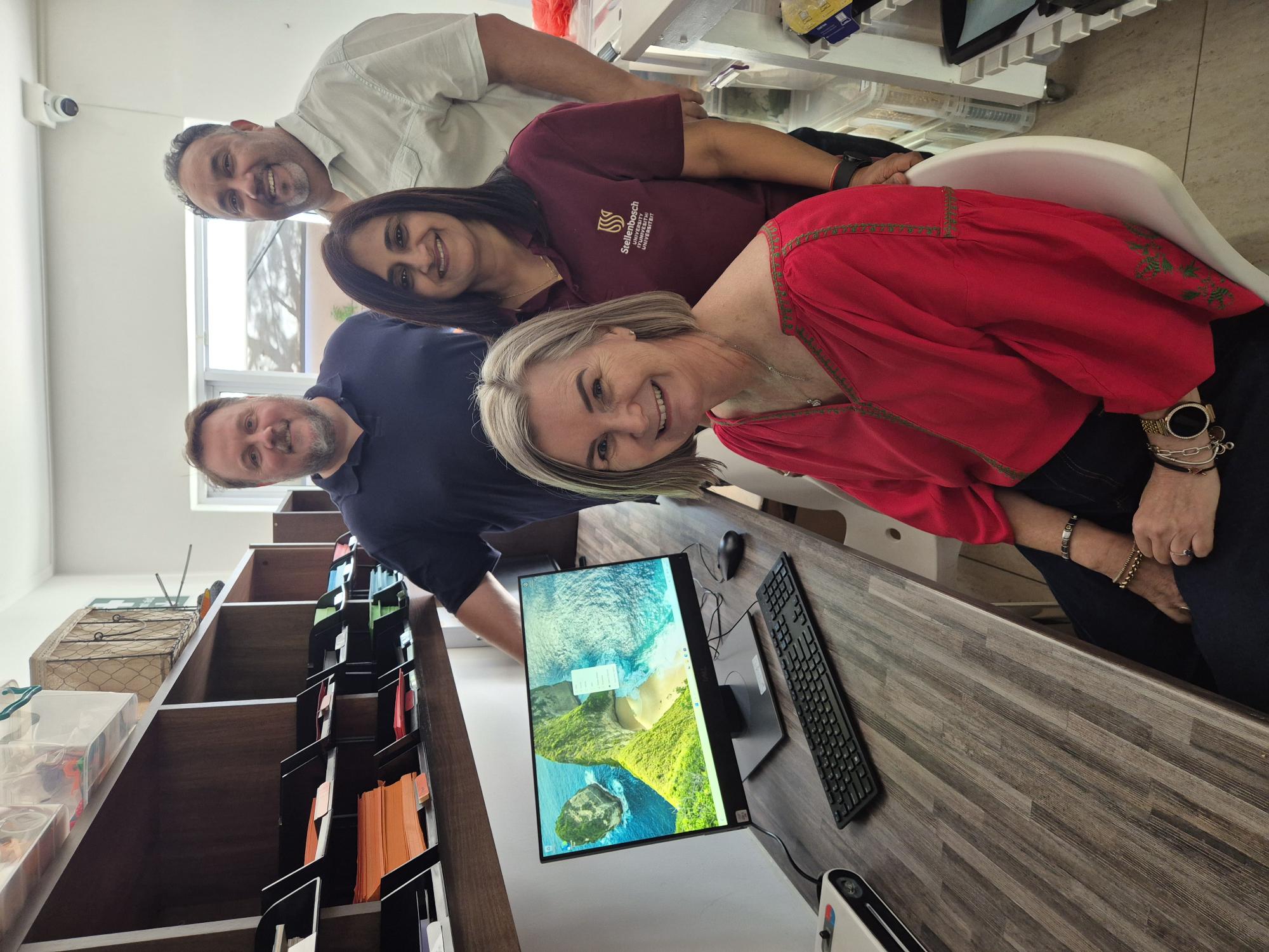 Mrs Lorain du Plessis Smit, Principal of Junior Akademie (sitting), with Mrs Heena Jivan, Head of IT and Operations of the Faculty of Economic and Management Sciences and two of her team members, Chris Bosman (with blue shirt) and Thurlo Muller.