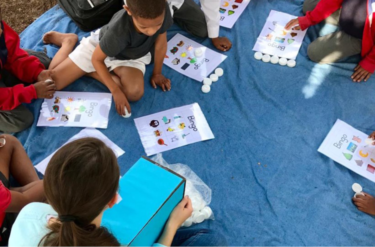 Children sitting in circle reading.