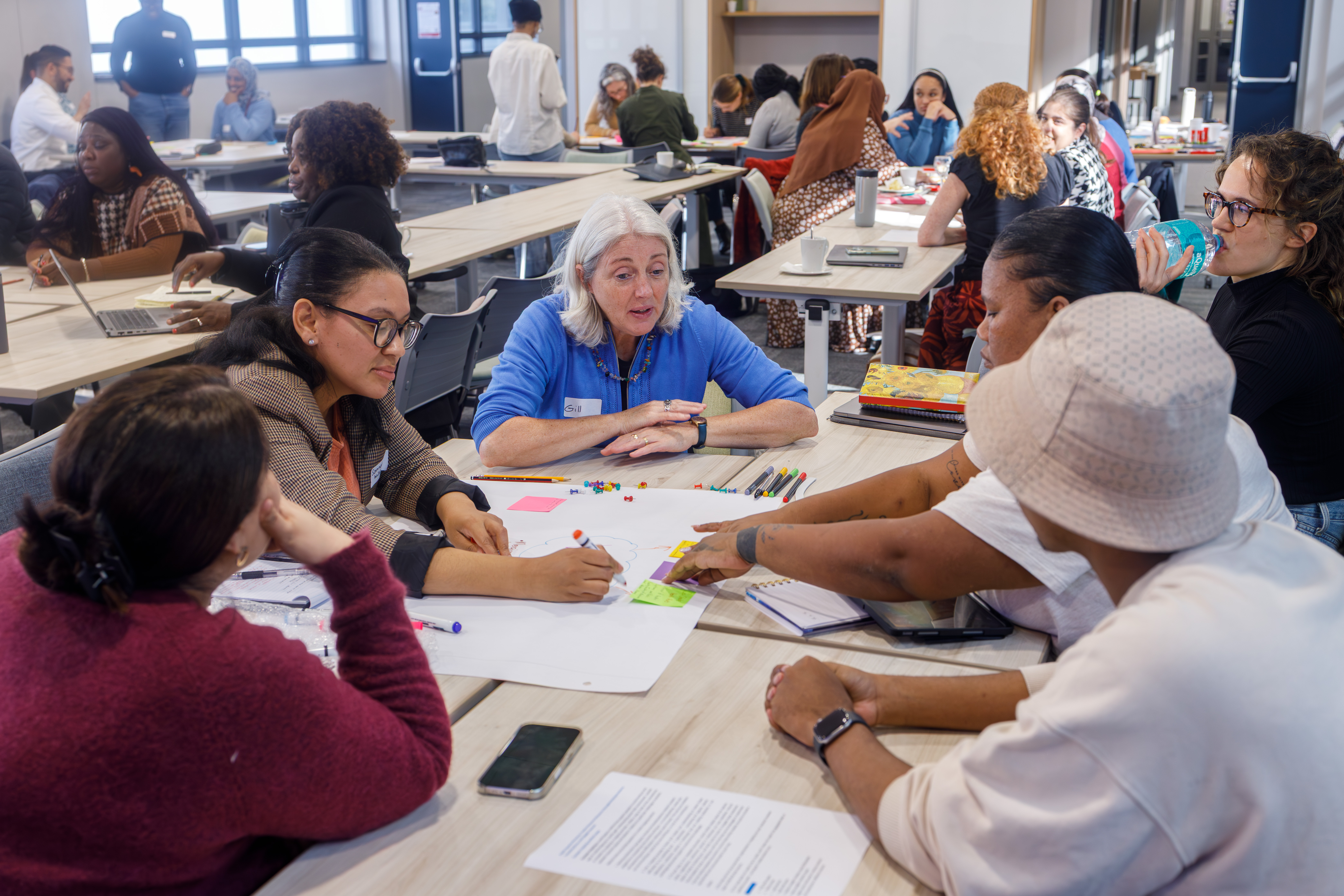 Dr. Gill Black explaining the details of context mapping to attendees during a workshop at the Creative Research Methods session