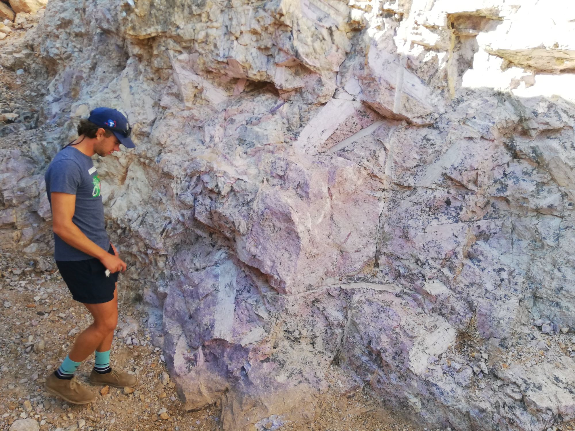 A BSc earth science student inspecting a "rock of interest".