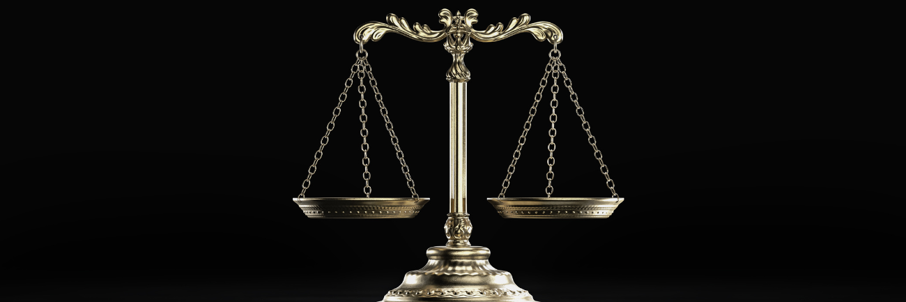 An illustration of Libra scales of justice against a black background.