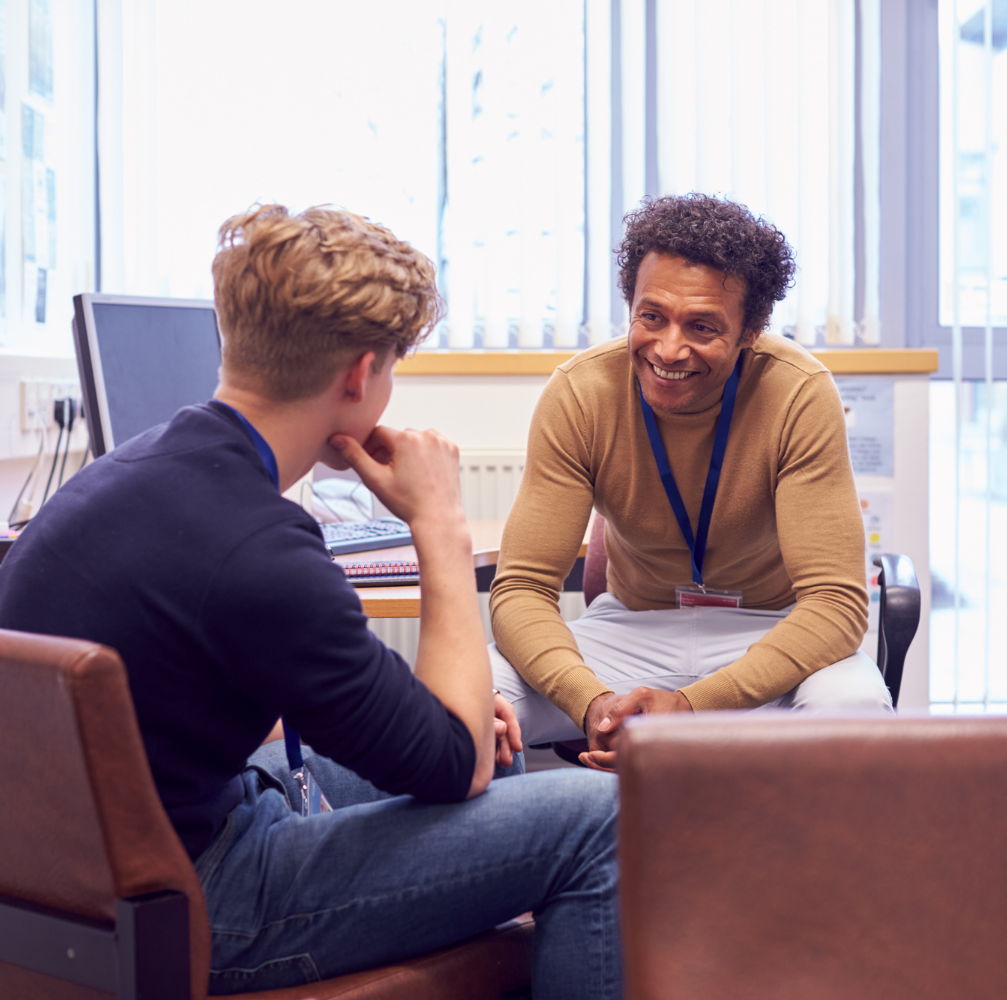 Photo of academic counsellor talking to male student