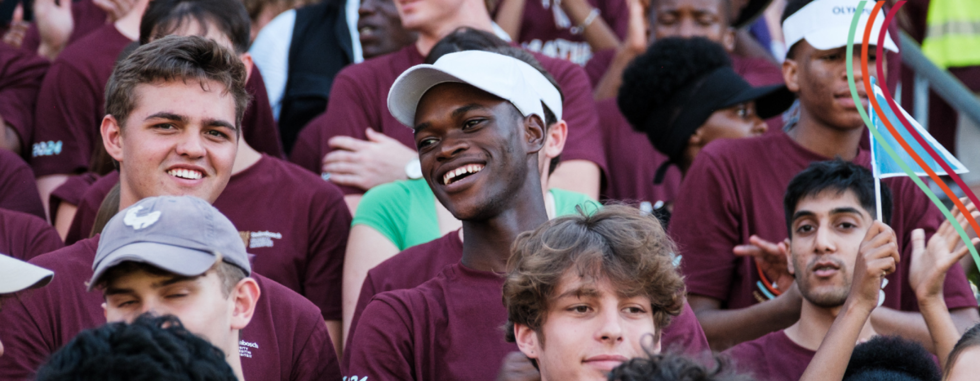 This is a photo of male students at the Coetzenburg Stadium during the Rector's Welcoming in 2025. They are wearing the Maties Newcomers t-shirts.