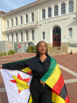 Shanice Kantuchitani, International Student from Zimbabwe oon campus with the ZImbabwean flag