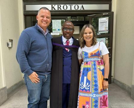 International Student and SUI Driver Moses Shambare, on his graduation day for Theology, standing with his managers at SUI, Ms Appollis, and Mer Leukes