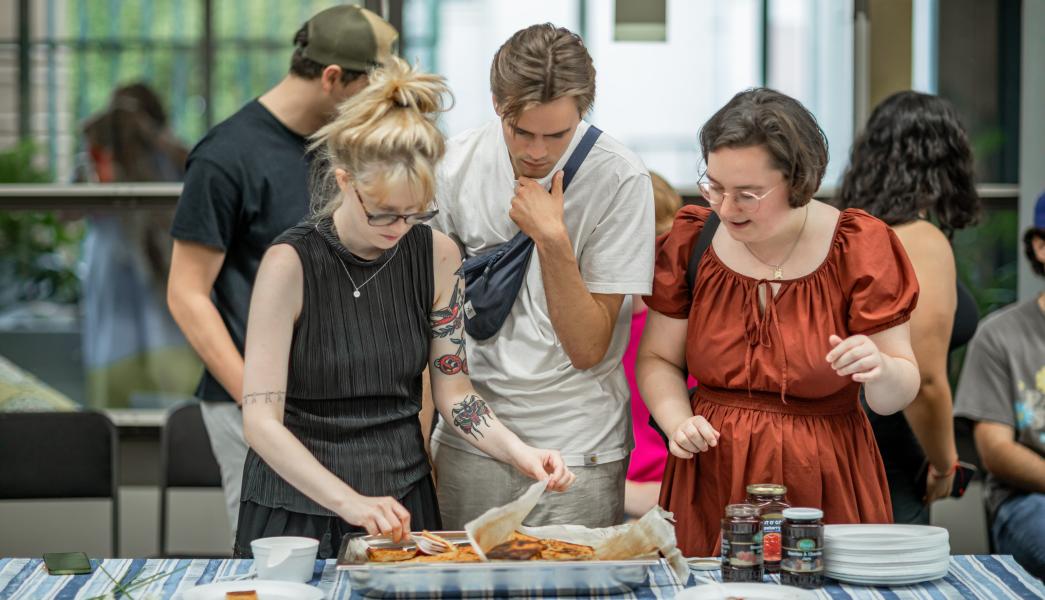 A photo of a group of people buying food at the international food evening