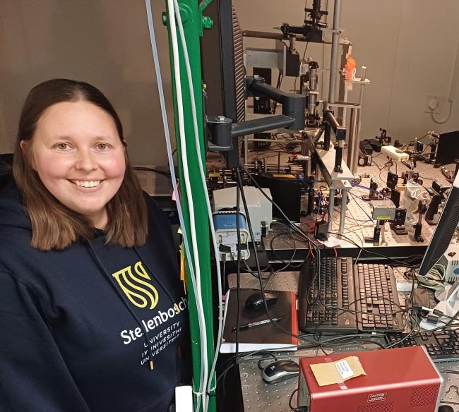 Dr Anneke Erasmus at the optical trapping she designed and built in a photonics lab in the Merensky Building, Department of Physics