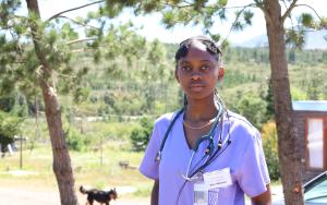 Doctor with a shack in the background
