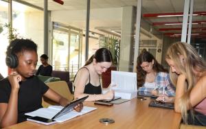 Students studying together at a table in the SU Library