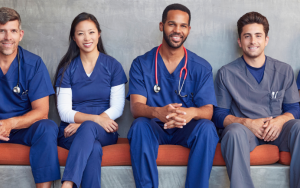 A group of male and female healthcare workers photographed sitting in a modern hospital