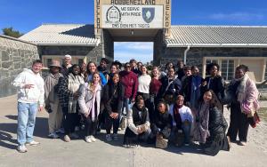 A photo of the 34 head mentors in front of the Robben Island prison gates during their visit to Robben Island as part of the SU Mentor programme’s experiential learning curriculum