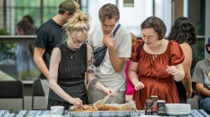 A photo of a group of people buying food at the international food evening