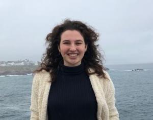 Shani Lange smiling in front of the sea