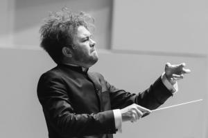 conducting student with orchestra