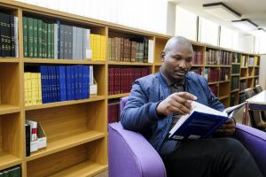Man reading a book in the library