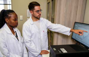 Click the icon to access the MY.SUN dashboard. A picture of students pointing to the screen. 