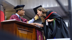 Picture of the rector capping a student at graduation