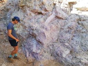 A BSc earth science student inspecting a "rock of interest".