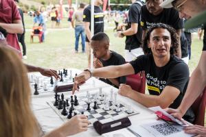Photo of newcomers playing chess at the Chess Club, one of the university's student societies