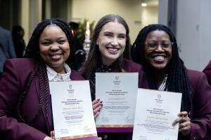Photo of three former TSRC members with certificates acknowledging their contribution to the TSRC.