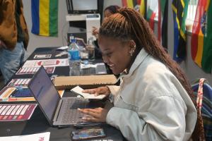 SU Student sitting by a computer during orientation week