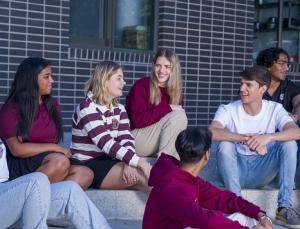 SU Student sitting by a computer during orientation week