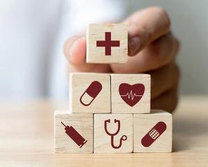 Photo of wooden building block with icon of medical objects 