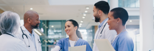 A diverse group of medical practitioners talking at a healthcare facility