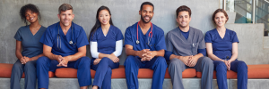 A group of male and female healthcare workers photographed sitting in a modern hospital