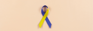 A picture of a blue and yellow ribbon that is the primary symbol for Down syndrome awareness.