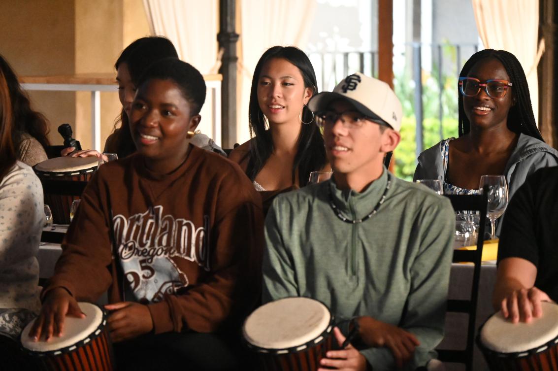 Participants from the SU International Summer School participating in  African drumming lessons